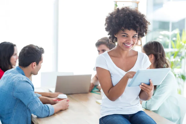 Colleagues using laptop and tablet in office — Stock Photo, Image