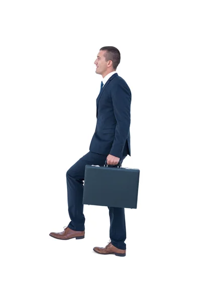 Businessman climbing with briefcase — Stock Photo, Image