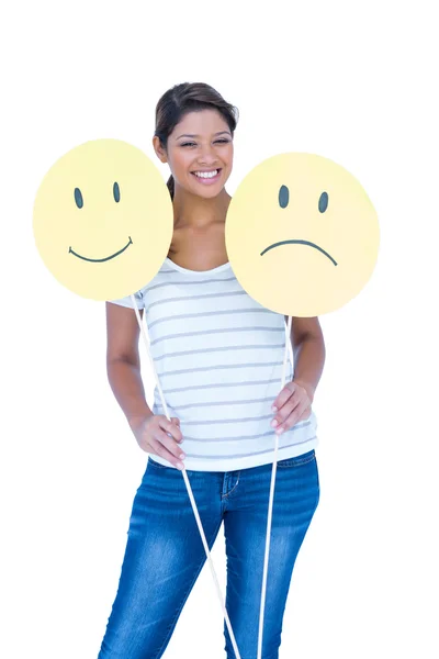 Brunette holding smileys faces — Stock Photo, Image