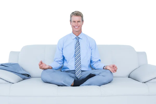 Businessman meditating in yoga pose — Stock Photo, Image