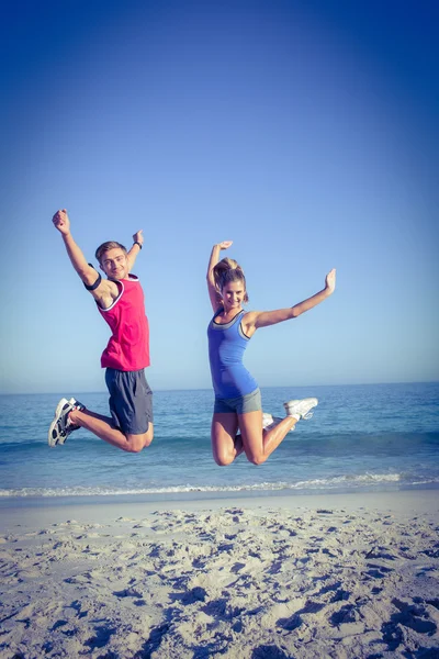 Happy couple jumping together — Stock Photo, Image