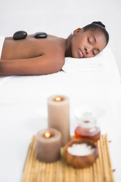 Woman enjoying hot stone massage — Stock Photo, Image