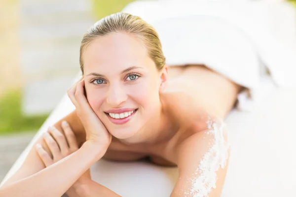 Close up portrait of a beautiful young woman on massage table — Stock Photo, Image