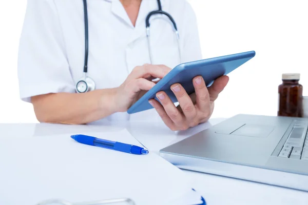 Doctor using a tablet in office — Stock Photo, Image