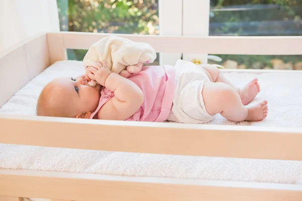 Cute baby girl in her crib — Stock Photo, Image