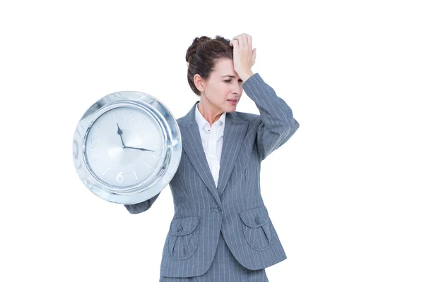 Businesswoman in suit holding a clock — Stock Photo, Image