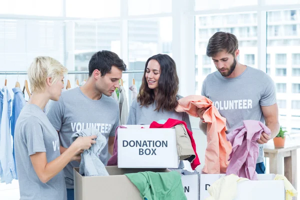 Volunteers separating donation stuffs — Stock Photo, Image