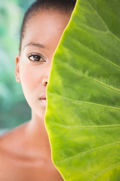 Woman looking through leaves — 스톡 사진