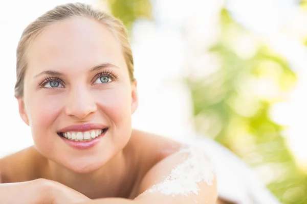 Close up portrait of a beautiful young woman on massage table — Stock Photo, Image