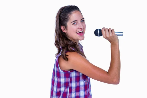 Brunette singing on microphone — Stock Photo, Image