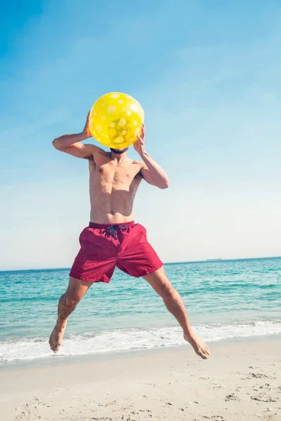 Happy man jumping on the beach — Stock Photo, Image