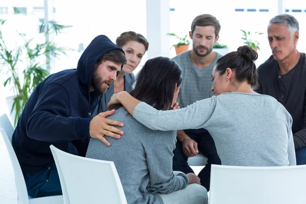 Concerned patients comforting another in rehab group — Stock Photo, Image