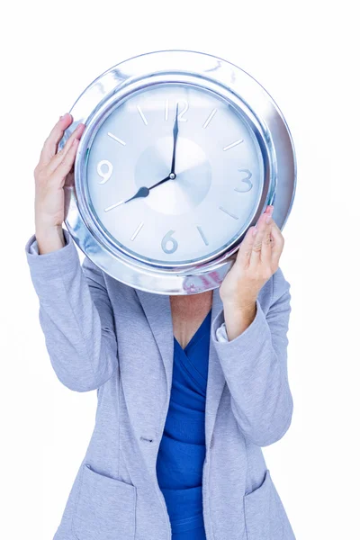 Businesswoman hiding her head with clock — Stock Photo, Image