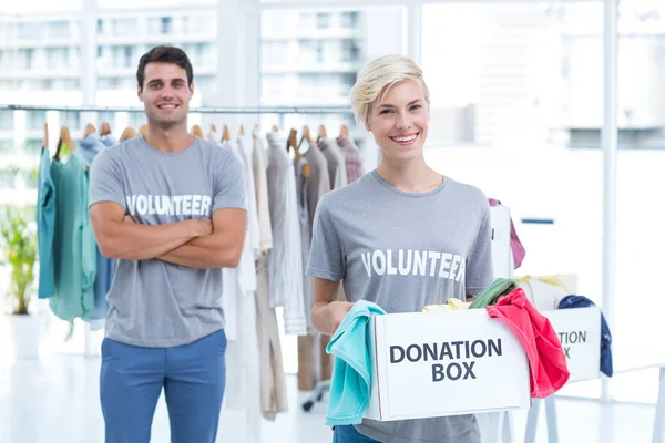 Blonde volunteer holding a donation box — Stock Photo, Image