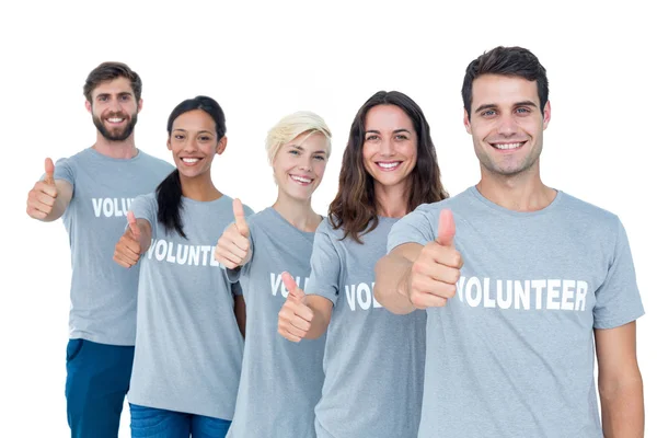 Happy volunteers friends gesturing thumbs up — Stock Photo, Image