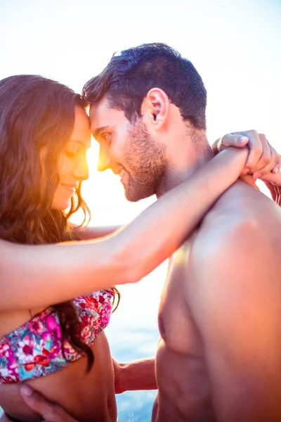 Sorridente coppia di fronte a vicenda sulla spiaggia — Foto Stock