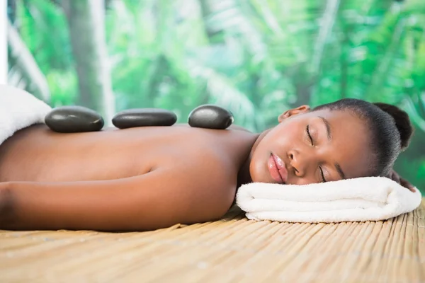 Woman enjoying hot stone massage — Stock Photo, Image