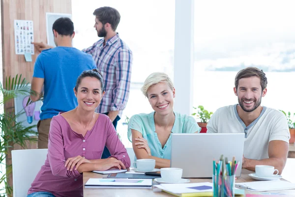 Creative colleagues using laptop in meeting — Stock Photo, Image