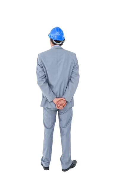 Businessman with helmet turning back — Stock Photo, Image