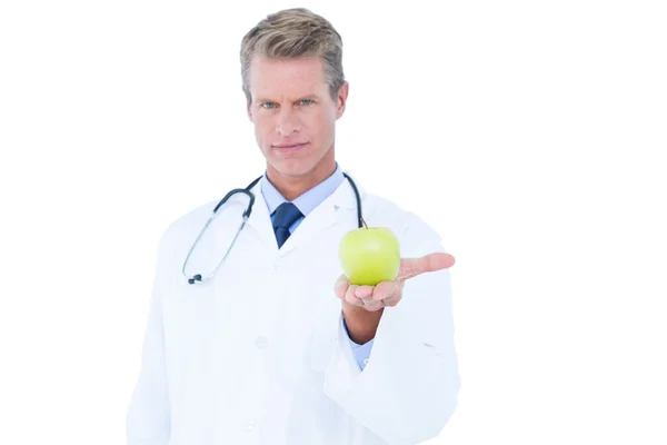 Doctor holding green apple — Stock Photo, Image