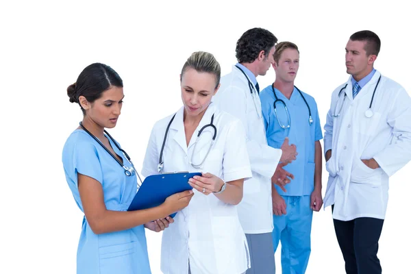 Doctor and nurse discussing over notes — Stock Photo, Image