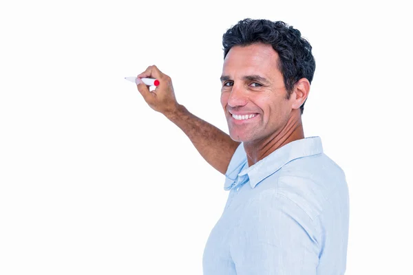 Handsome man writing something with red markers — Stock Photo, Image