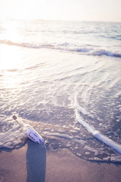 Message in a bottle on beach — Stock Photo, Image