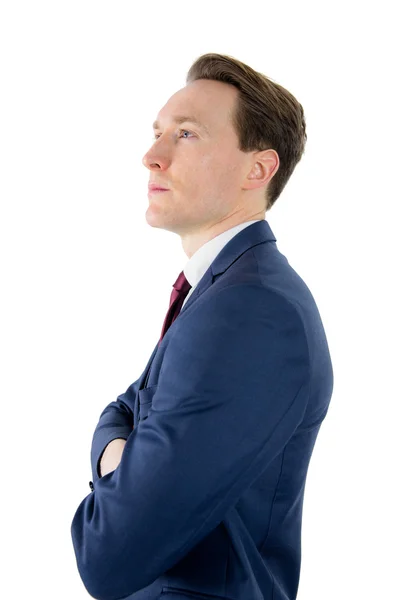 Thoughtful businessman looking away with arms crossed — Stok fotoğraf