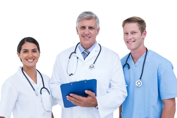 Doctors and nurse discussing over notes Stock Image