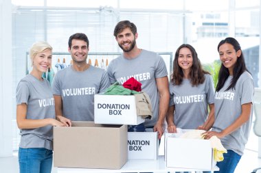 Volunteers separating donation stuffs clipart