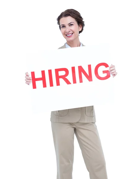 Businesswoman holding a hiring sign — Stock Photo, Image