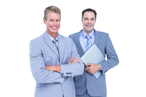 Business team standing arms crossed and with a folder — Stock Photo, Image