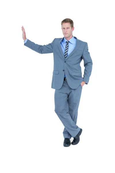 Businessman standing against wall — Stock Photo, Image