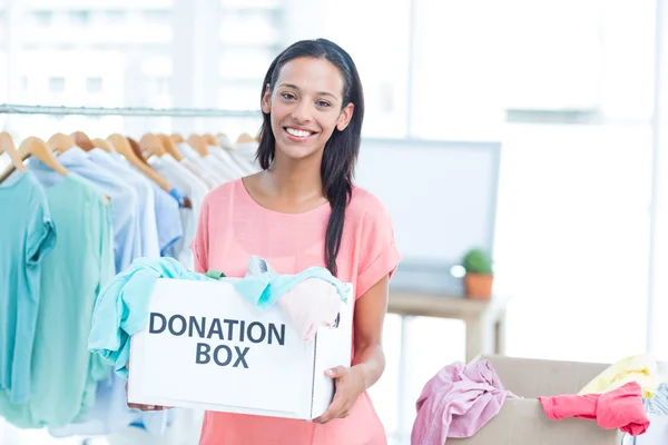 Volonteer sonriente sosteniendo una caja de donaciones — Foto de Stock