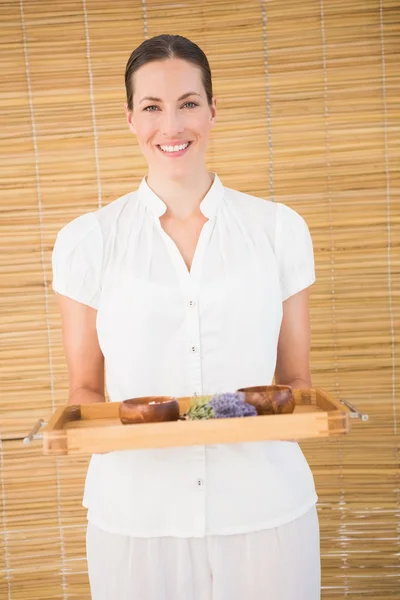 Therapist holding tray of treatments at spa — Stock Photo, Image