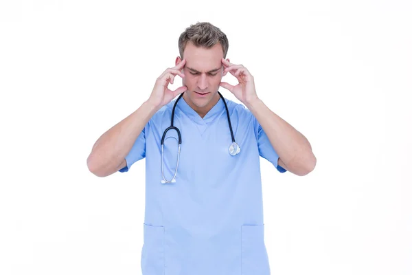 Worried young nurse in blue tunic — Stock Photo, Image