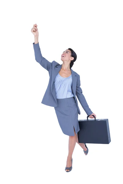 Businesswoman gesturing and holding briefcase — Stock Photo, Image