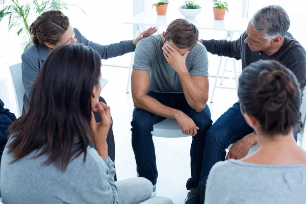 Concerned patients comforting another in rehab group — Stock Photo, Image