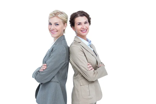 Serious businesswomen standing back on back — Stock Photo, Image