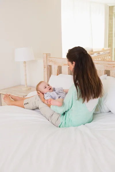 Mother with baby boy in bedroom — Stockfoto