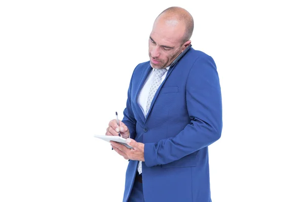 Joven empresario escribiendo en un bloc de notas —  Fotos de Stock