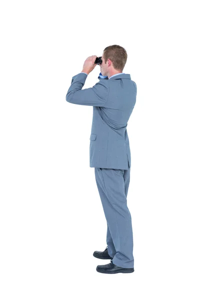 Businessman looking through binoculars — Stock Photo, Image