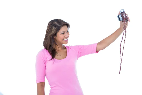 Pretty brunette taking a selfie with retro camera — Stock Photo, Image