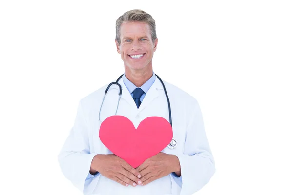 Smiling doctor holding heart card — Stock Photo, Image