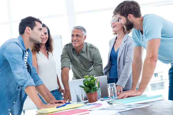 Casual colleagues using laptop in the office — Stock Photo, Image