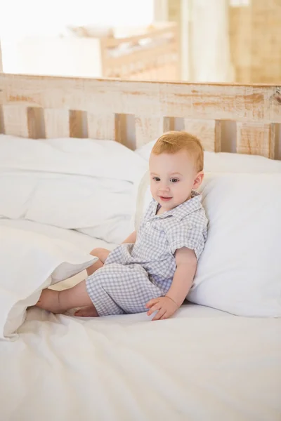 Cute baby boy in bedroom — Stok fotoğraf