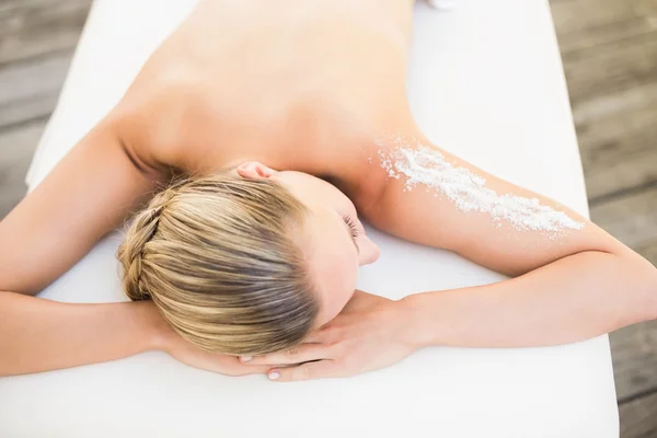 Beautiful woman lying on massage table — Stock Photo, Image