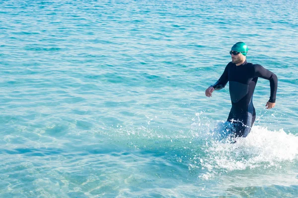Swimmer running in the ocean — Stockfoto