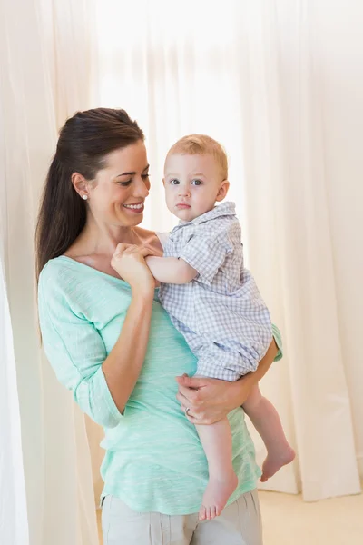 Happy mother holding baby boy — Stock Photo, Image