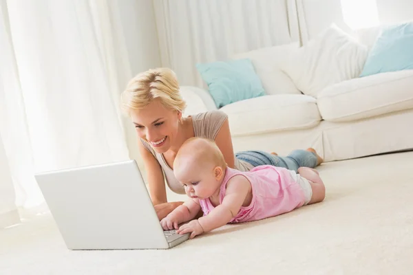 Мать с ребенком девочка с помощью ноутбука — стоковое фото